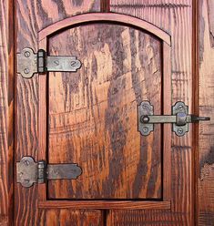 an open wooden door with metal handles