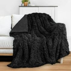 a couch with a black blanket on top of it