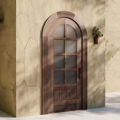 a wooden door with glass on the side of a stone building next to a planter