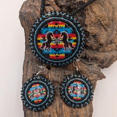 Beautiful matching medallion/earring set. Rows of Blue and black beads that make the "Pop Cap" tab centers pop! Genuine leather backing. The medallion is almost 3-inches in diameter and the chain is 15-inches long. The earrings measure 2-inches in diameter. Hand Beaded by Josie Basswood, a Anishinaabe/ Ojibwe tribal artisan of Pine Point, Minnesota. Artisan Jewelry With Black Round Beads, Traditional Black Medallion Shaped Jewelry, Traditional Beaded Medallion Jewelry, Multicolor Beaded Medallion Jewelry, Beaded Medallions Native American, Eagle Beaded Medallion, Beaded Bear Medallion, Hand Beading, Black Beads