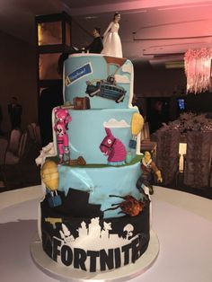 a three tiered cake is decorated with cartoon characters and other things on the side