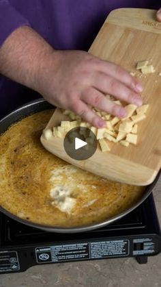 a person cutting up food on top of a stove