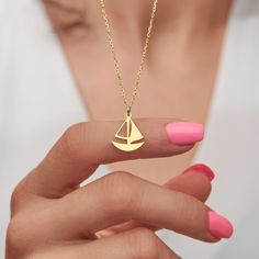 This exquisite necklace captures the adventurous spirit of the open sea with its elegant sailboat design. Crafted from stunning 14k gold, this necklace is a true treasure that will never go out of style. The 14k gold construction adds a touch of luxury and refinement to the necklace, ensuring that it will be a cherished piece in your jewelry collection for years to come. The bright and shining gold catches the light beautifully, creating a radiant glow that will complement any outfit. This sailb Tiny Sailboat, Profile Unique, Sailboat Necklace, Metal Jewelry Making, Candy Necklace, Sailboat Design, Pearl Necklace Designs, Beaded Jewels, Jewelry Dainty