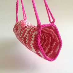 pink and white crocheted heart hanging from strings