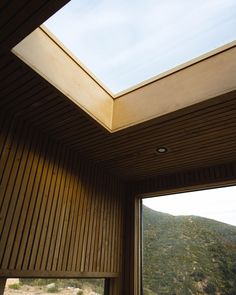 a room with a skylight and wooden walls