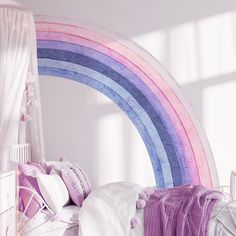 a bed room with a neatly made bed and a rainbow