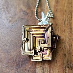 This medium Bismuth crystal necklace is one of a kind. These pendants are formed by melting the Bismuth and allowing the crystals to form naturally. Each piece is completely unique. There are two different kinds of pendants. Flat and 3D. Please choose which type you desire. Bismuth is element #83 on the periodic table of elements and has an atomic weight of 208.98. Something interesting about it is that it expands when it cools... which creates crystals! I can melt it down to create and shape these beautiful Bismuth Necklaces! The beautiful colors that it produces comes from how the light waves interact with the differing numbers of oxide layers. Dimensions: Weight: 12-20 Grams Length: 1.25-1.75 In (3.81 Cm) Width: 0.5-0.75 In (1.91 Cm) You may or may not get the necklace pictured, but you Unique Pendant Crystal Necklaces For Gifts, Unique Silver Crystal Necklace Gift, Unique Silver Crystal Necklace For Gift, Silver Electroformed Crystal Necklace, Iridescent Pendant Crystal Necklace For Gift, Iridescent Crystal Pendant Necklace For Gift, Spiritual Soldered Crystal Necklace As Gift, Spiritual Electroformed Crystal Necklaces As Gifts, Spiritual Electroformed Crystal Necklace As Gift