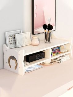 an alarm clock is sitting on top of a white shelf in front of a mirror