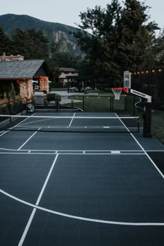 an outdoor basketball court in the evening