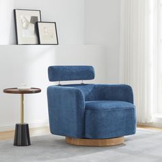 a blue chair sitting on top of a wooden table in a living room next to a window