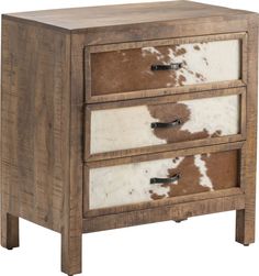 a brown and white cow hide chest with three drawers