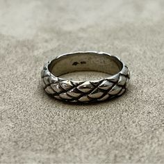 a silver ring sitting on top of a carpet