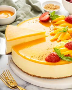 a cheesecake with strawberries and oranges on the top is ready to be eaten