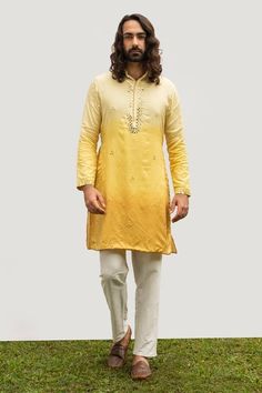 Yellow bam silk ombre shaded kurta with mirror embroidery. Comes with ivory cotton silk pyjama pant.
Component: 2
Pattern: Embroidered
Type Of Work: Mirror
Neckline: Mandarin collar
Sleeve Type: Full
Fabric: Kurta : Bam silk, Pant : Cotton silk
Color: Yellow
Other Details: 
Embroidered collar and placket
Occasion: Mehendi and Puja - Aza Fashions Kurta And Dupatta, Mens Indian Wear, Silk Pajama Pants, Wedding Kurta For Men, Yellow Kurta, Haldi Outfits, Traditional Suit, Mirror Embroidery, Silk Pant