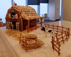 a gingerbread house with farm animals and hay