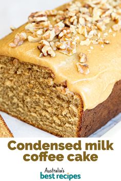 a close up of a loaf of cake with frosting on top and nuts in the middle