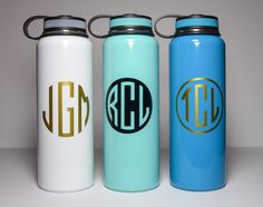 three personalized stainless steel water bottles in different colors and designs, one with the initials on it