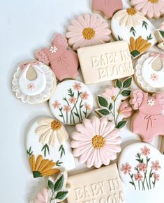 baby shower cookies decorated with pink and yellow flowers