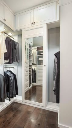 a walk in closet filled with lots of clothes