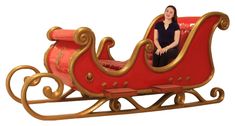 a red and gold sleigh sitting on top of a white background