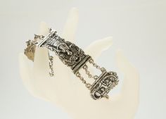 A silver bracelet made of antique bible closure created in 1800s. The free links of the bracelet depict different biblical figures on a floral background and are connected with each other by means of three row chain. The bracelet is not marked for the silver content, but it tests positive for high content silver. The bracelet is in very good antique condition. There are no damages or other issues to be mentioned, just normal to its age signs of wear and time. Measurements:  length: 18 -20 cm, wi Antique Bible, Floral Background, Chain Link Bracelet, Link Bracelets, Bracelet Making, Chain Link, Favorite Jewelry, Antique Silver, Netherlands