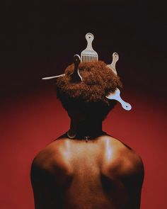 the back of a man with scissors and combs on his head