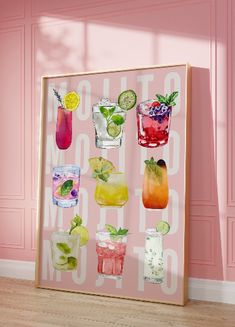 a pink wall with drinks on it and the words mojito written in white