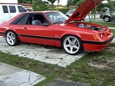 a red sports car with its hood open