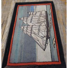 an area rug with a ship on it