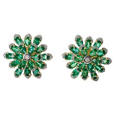 Our Gorgeous Emerald and Diamond flower stud earrings are beautifully hand crafted in 18 karat yellow gold. The details are as follows : Emerald weight : 7.48 carat ( vivid green color ) Diamond weight : 0.57 carat ( GH color and VS clarity ) Metal : 18K yellow gold Measurements : 1inch by 1 inch or 22.5mm by 22.5 mm Gold weight : 13.500 grams Luxury Green Diamond Earrings Gift, Luxury Green Diamond Earrings For Gift, Green Hand-set Diamond Earrings, Green Hand Set Diamond Earrings, Luxury Green Diamond Earrings With Prong Setting, Luxury Green Earrings With Prong Setting, Green Luxury Earrings With Prong Setting, Formal Green Diamond Cluster Earrings, Luxury Green Flower-shaped Jewelry