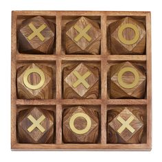 wooden tic - tac - toe game with gold numbers and symbols in it