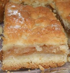 several pieces of cake sitting on top of a piece of tin foil covered in powdered sugar