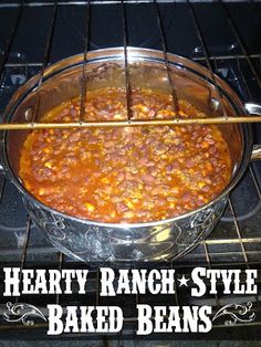 a pot filled with beans cooking on top of an open oven door next to the words hearty ranch style baked beans