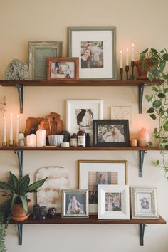 some shelves with pictures and candles on them