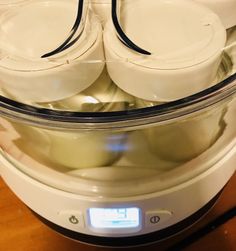 an automatic cooker filled with food on top of a wooden table