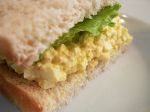 a sandwich with eggs and lettuce on it