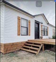 a mobile home with steps leading to the front door