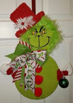 the grinch door hanger is decorated with christmas decorations