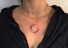 a woman with a crescent tattoo on her chest