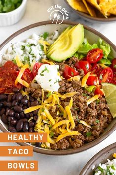 healthy taco bowls with tortilla chips and avocado on the side