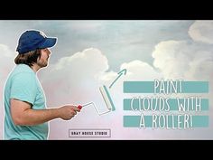 a man holding a paint roller in front of a painting with clouds behind him and the words paint clouds with a roller