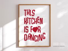 this kitchen is for dancing poster hanging on the wall in front of a white wall