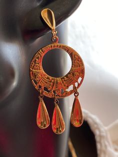 These are stamped, lightweight, gold Vermeil earrings. They are a wonderful, ethnic design. The earrings are unique, and comfortable to wear., They are 2 1/2 inches long, and 1 1/8 inches wide. Gold Dangle Clip-on Earrings With Latkans, Vintage Gold Pierced Danglers, Gold Vintage Danglers With Latkans, Gold Vintage Danglers, Bohemian Gold Chandelier Earrings With Pierced Style, Gold Teardrop Chandelier Earrings For Festivals, Gold Bohemian Dangle Chandelier Earrings, Bohemian Gold Dangle Chandelier Earrings, Bohemian Gold Chandelier Earrings