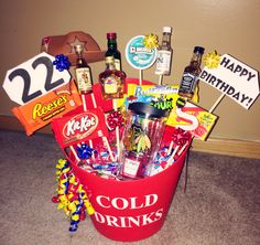 a red bucket filled with liquor and candy