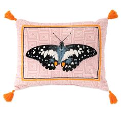 a pink pillow with a black and white butterfly on it