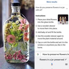 a bottle filled with flowers sitting on top of a table next to an email message