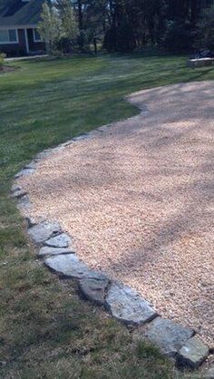 a gravel driveway in front of a house