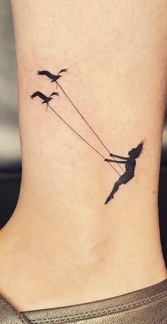 a woman with birds flying behind her on the ankle