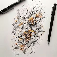 a drawing of flowers and leaves on a white paper with a pen next to it