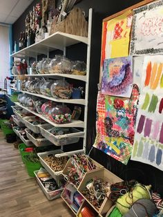 a room filled with lots of crafting supplies and crafts on shelves next to each other